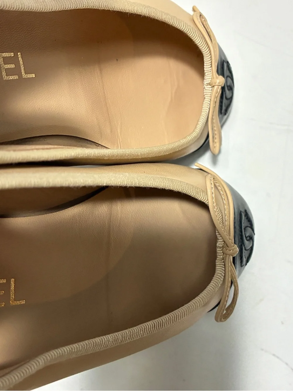 CHANEL Beige Leather Ballet Flats with Black Cap Toe and CC Logo